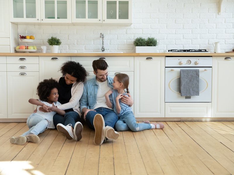 family sitting on kitchen floor